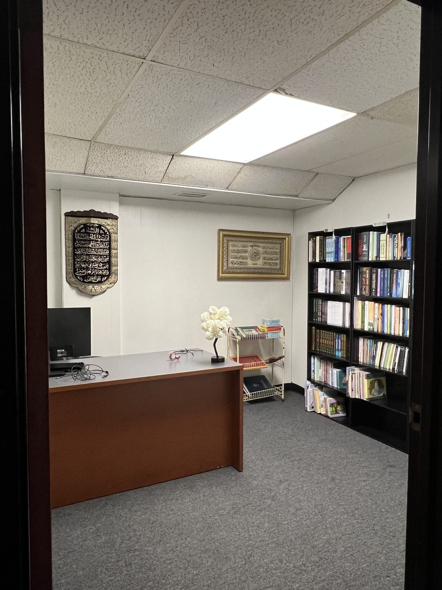 The ALI Center library room with shelves of Islamic books and a reading desk